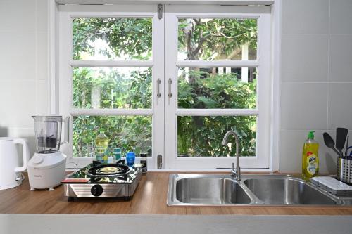 a kitchen counter with a sink and a window at Bao Village in Haad Yao