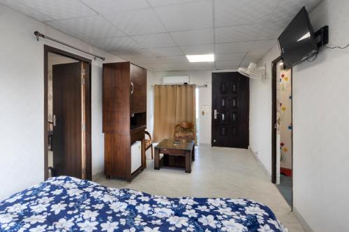 a bedroom with a bed and a room with a desk at InnBox Farmstay - Rajpura Punjab in Banūr