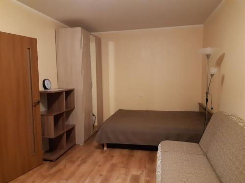 a bedroom with a bed and a couch in a room at Apartments near the center and airport in Tallinn