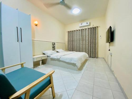 a bedroom with a bed and a tv in it at Low Priced New Residential Rooms for Men Guests near DAFZA Metro Station in Dubai