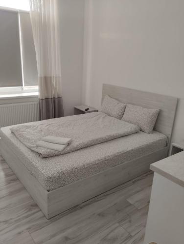 a bed in a white room with a bedvisor at PARK-hotel in Cahul