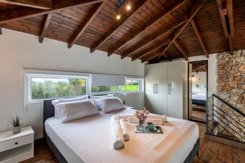 ein Schlafzimmer mit einem großen Bett und einer Steinmauer in der Unterkunft EPTA Houses in Marmari