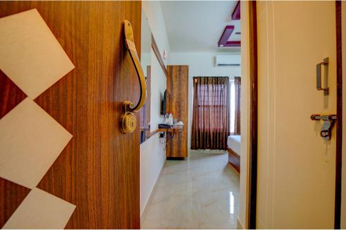 an open door to a room with a hallway at FabHotel Greenwood Xpress Inn - Nr Manipal Hospital in Bengaluru