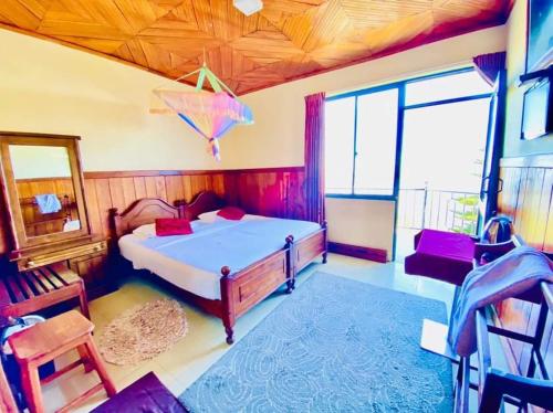 a bedroom with a large bed and a window at Srilak View Holiday Inn in Haputale