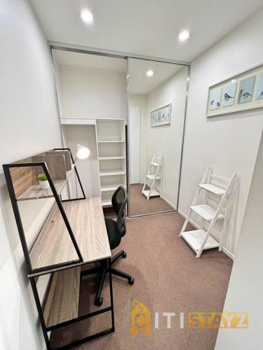 a room with two bunk beds and a mirror at Bright in Braddon! 1 bd 1bth Apt in Canberra