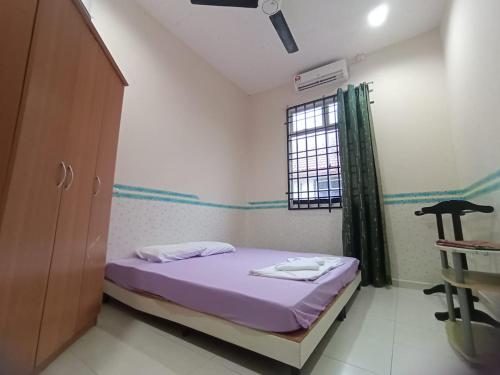 a small room with a bed and a window at Seaview Promenade Homestay Dungun in Dungun