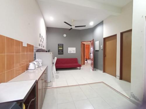 a kitchen with a red couch in a room at Seaview Promenade Homestay Dungun in Dungun