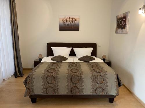 a bedroom with a large bed with a brown comforter at FeWo am Zwinger 2 in Dresden