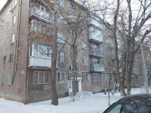 an apartment building with snow in front of it at Apartaments in the city center in Karagandy