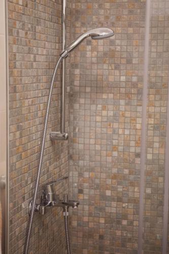 a shower in a bathroom with a brick wall at Villa Helena in Podgora