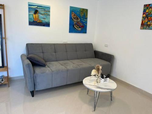 a living room with a couch and a table with a dog on it at נווה מדבר in Eilat