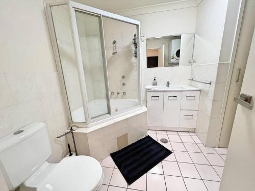 a bathroom with a toilet and a shower and a sink at Beautiful & enclosed, 1 bd 1 bth - close to CBR Hospital in Phillip
