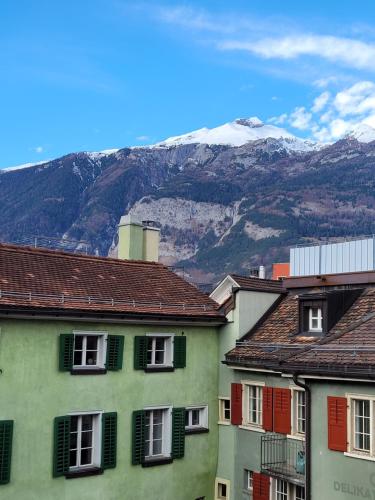 a group of houses with mountains in the background at Zunfthaus zur Rebleuten in Chur