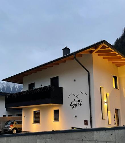 a building with a sign on the side of it at Apart Egger in Schwendau