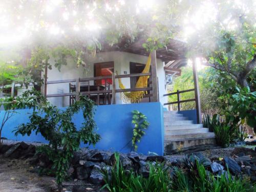a house with a blue wall and stairs to it at Stay Cool Pipa in Pipa