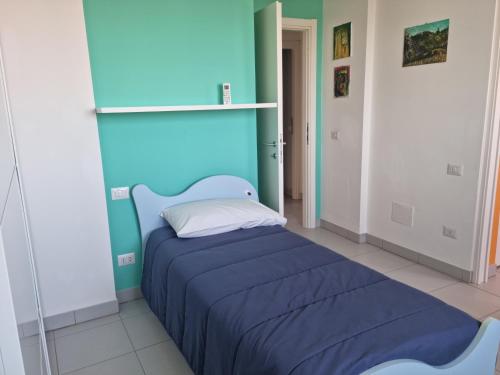 een blauwe slaapkamer met een bed in een kamer bij CASA FLAN in Porto San Giorgio
