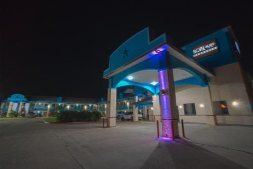 a gas station with a lit up sign in front of it at Hotel Bliss Kemah in Kemah