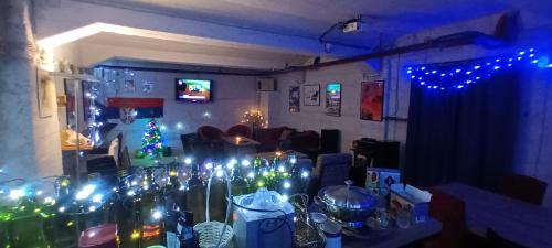 a room with christmas lights and a living room with a table at Authentic Belgrade Centre Hostel - Only private rooms in Belgrade