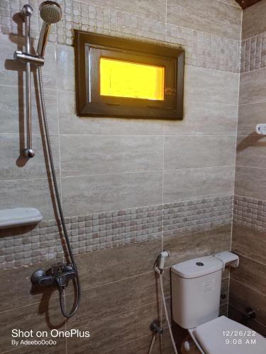 a shower in a bathroom with a toilet and a window at Mermaid camp in Nuweiba