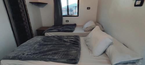 two beds in a small room at Torya Nubian House in Aswan