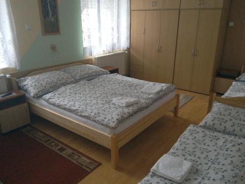 a small bedroom with two beds and cabinets at Apartmány pod Suchým Vrchem in Orličky