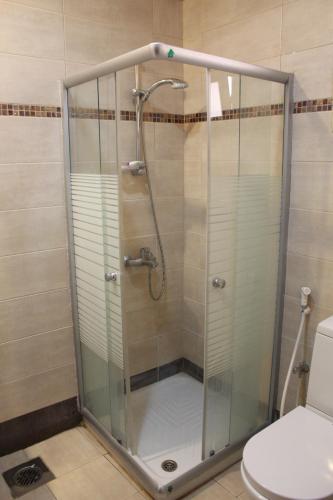 a shower stall in a bathroom with a toilet at ماجيك سويت المهبولة 5 Magic Suite ALMahboula 5 in Kuwait