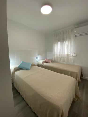 two beds sitting next to each other in a room at piso junto al hospital macarena in Seville