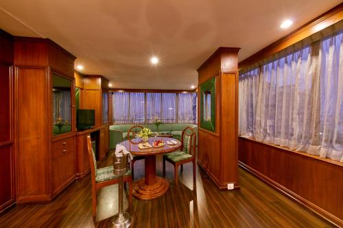 a dining room with a table and chairs at Royal Orchid Central Bangalore, MG Road in Bengaluru