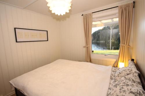 a bedroom with a bed and a window at Herøya Porsgrunn Apartment in Porsgrunn