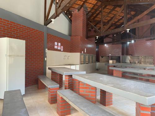 cocina grande con bancos y nevera blanca en Apartamento Ilhas do Sul, en Balneário Camboriú