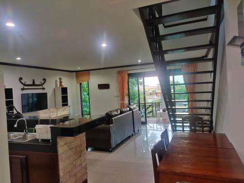 a kitchen and living room with a spiral staircase at BEA Privileged Apartment in Lamai