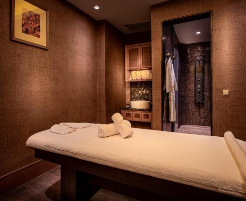 a room with a bed with towels on it at The Stay Boulevard Nisantasi in Istanbul
