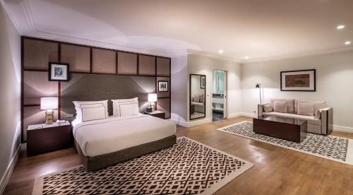a bedroom with a large bed and a couch at The Stay Boulevard Nisantasi in Istanbul