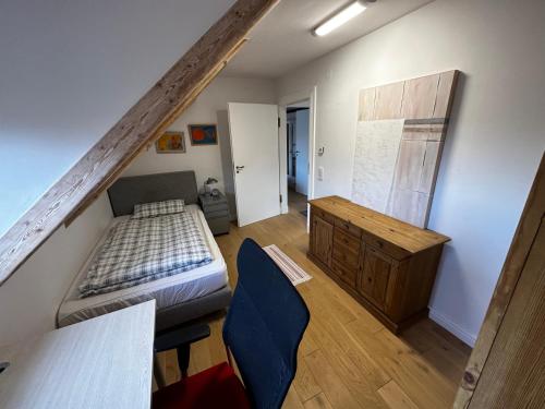 a bedroom with a bed and a dresser in a room at Spatzennest in Bad Harzburg