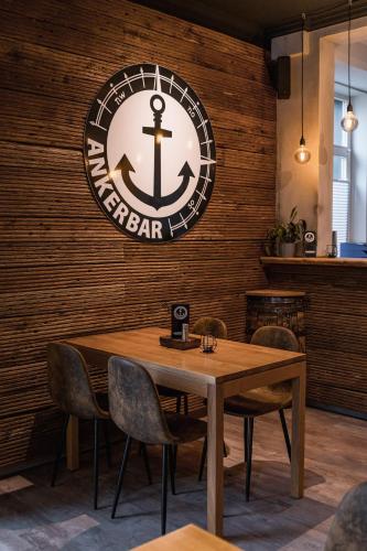 a dining room with an anchor sign on a wall at Villa Ludwigsburg in Kühlungsborn
