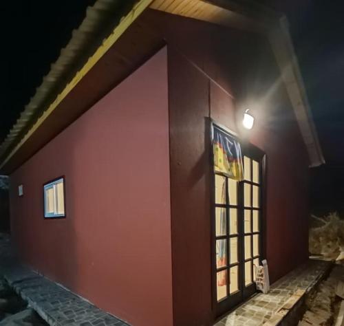 a red wall of a building with a window at Casa Cerro Arco in Mendoza