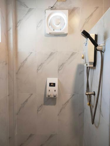 a shower in a bathroom with a shower at Golden House Hotel Sakaeo Room with breakfast in Sa Kaeo