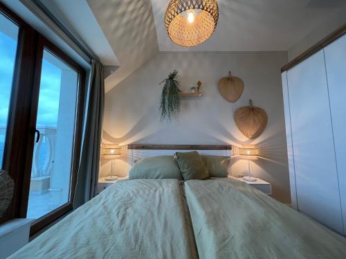 a bedroom with a bed and a large window at Sky & Sea Apartment in Golden Sands