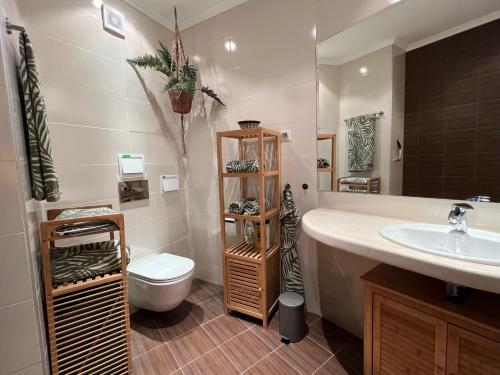 a bathroom with a sink and a toilet at Sky & Sea Apartment in Golden Sands