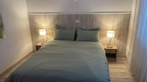 a bedroom with a large bed with two lamps at Sunset view in La Romantica, 3 in Los Realejos