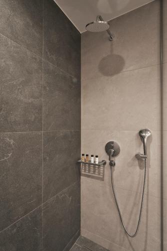 a shower with a shower head in a bathroom at Hestia - Dimitressa 4 in Athens