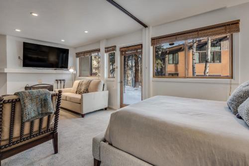 a bedroom with a bed and a couch and a tv at Laurelwood Condominiums 103 in Snowmass Village