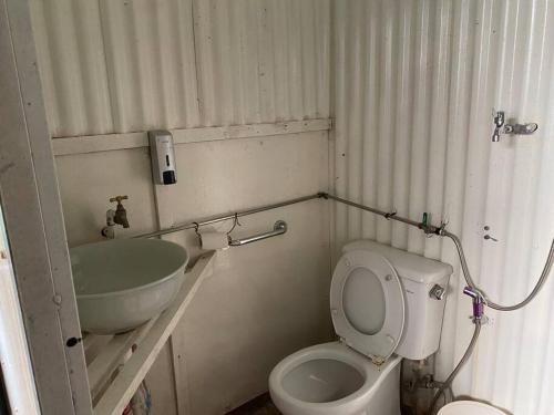 a small bathroom with a toilet and a sink at New Famer Hut 1 in Brinchang