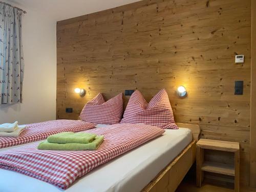 a bedroom with two beds with red and white pillows at Apartment-Chalet Mödlinghof in Hopfgarten im Brixental