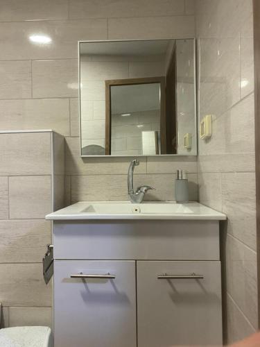 a bathroom with a sink and a mirror at Majdal Shams/989 Apartment in Nimrod