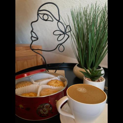 a table with a cup of coffee and some cupcakes at The Tara Concept in Šljivovica