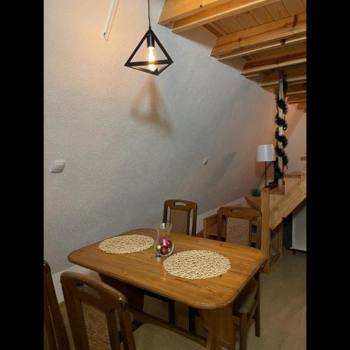 a wooden table and chairs in a room at The Tara Concept in Šljivovica