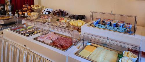 a refrigerator filled with different types of food at Hotel Villa Stucky in Mogliano Veneto
