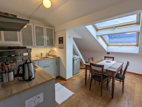 a kitchen and dining room with a table and chairs at Ferienwohnung Murnauer Moos in Murnau am Staffelsee