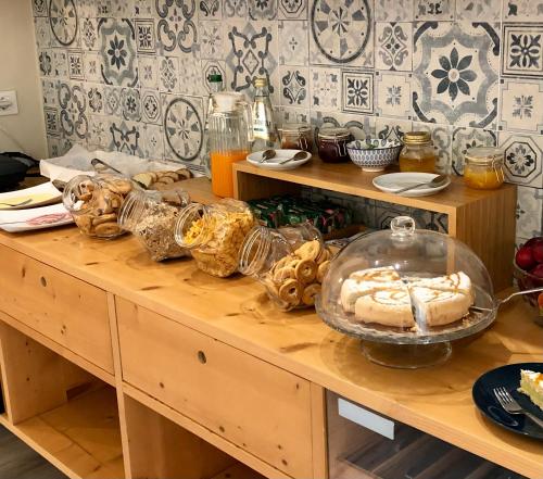 a table with bread and other food on it at Room 55 in Noto